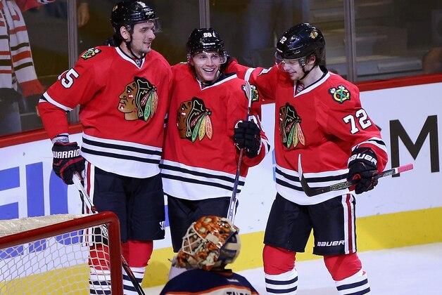 CHICAGO, IL - NOVEMBER 08:  (L-R) Artem Anisimov #15 Patrick Kane #88 and Artemi Panarin #72 of the Chicago Blackhawks celebrate a goal against the Edmonton Oilers at the United Center on November 8, 2015 in Chicago, Illinois. The Blackhawks defeated the Oilers 4-2.  (Photo by Jonathan Daniel/Getty Images)
