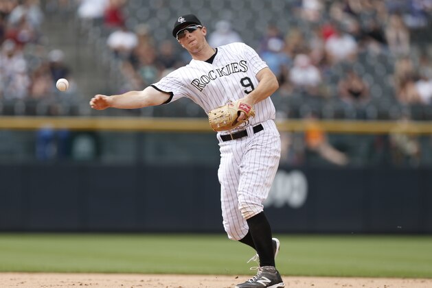 Colorado Rockies second baseman DJ LeMahieu (9) throws to first base for put out against the San Diego Padres in the eighth inning of a baseball game Sunday, Aug. 16, 2015, in Denver. The Rockies won 5-0. (AP Photo/David Zalubowski)