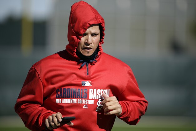 St. Louis Cardinals catcher Yadier Molina jogs during spring training baseball practice Wednesday, Feb. 17, 2016, in Jupiter, Fla. Molina has had the cast removed from his surgically repaired left thumb which he injured making a tag last season. (AP Photo/Jeff Roberson)