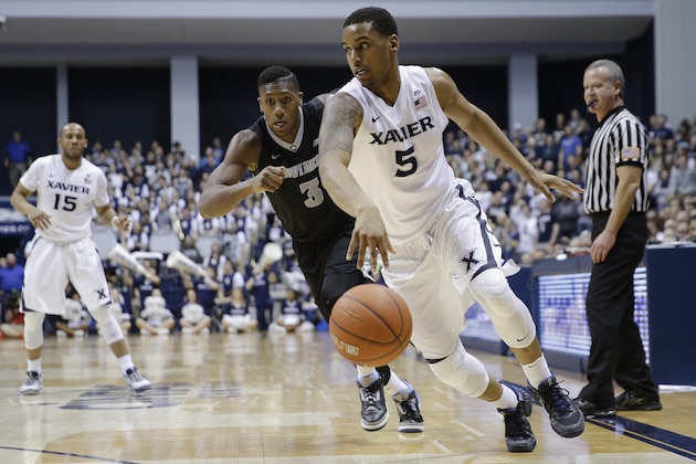 Xavier's Trevon Bluiett (5) drives past Providence's Kris Dunn (3) in the second half of an NCAA college basketball game Wednesday, Feb. 17, 2016, in Cincinnati. Xavier won 85-74. (AP Photo/John Minchillo)