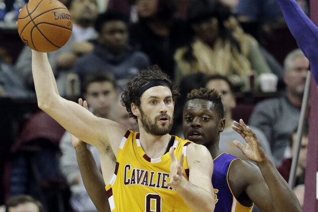 Cleveland Cavaliers' Kevin Love (0) looks to pass around Los Angeles Lakers' Julius Randle (30) in the first half of an NBA basketball game Wednesday, Feb. 10, 2016, in Cleveland. (AP Photo/Tony Dejak)