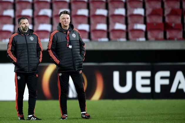 Manchester United coach Louis van Gaal, right, stands next to Ryan Giggs during a training session in Herning, Denmark, Wednesday, Feb. 17, 2016.  Manchester United will face FC Midtjylland for their Europa League first leg match on Thursday. (Lars Poulsen/POLFOTO via AP) DENMARK OUT