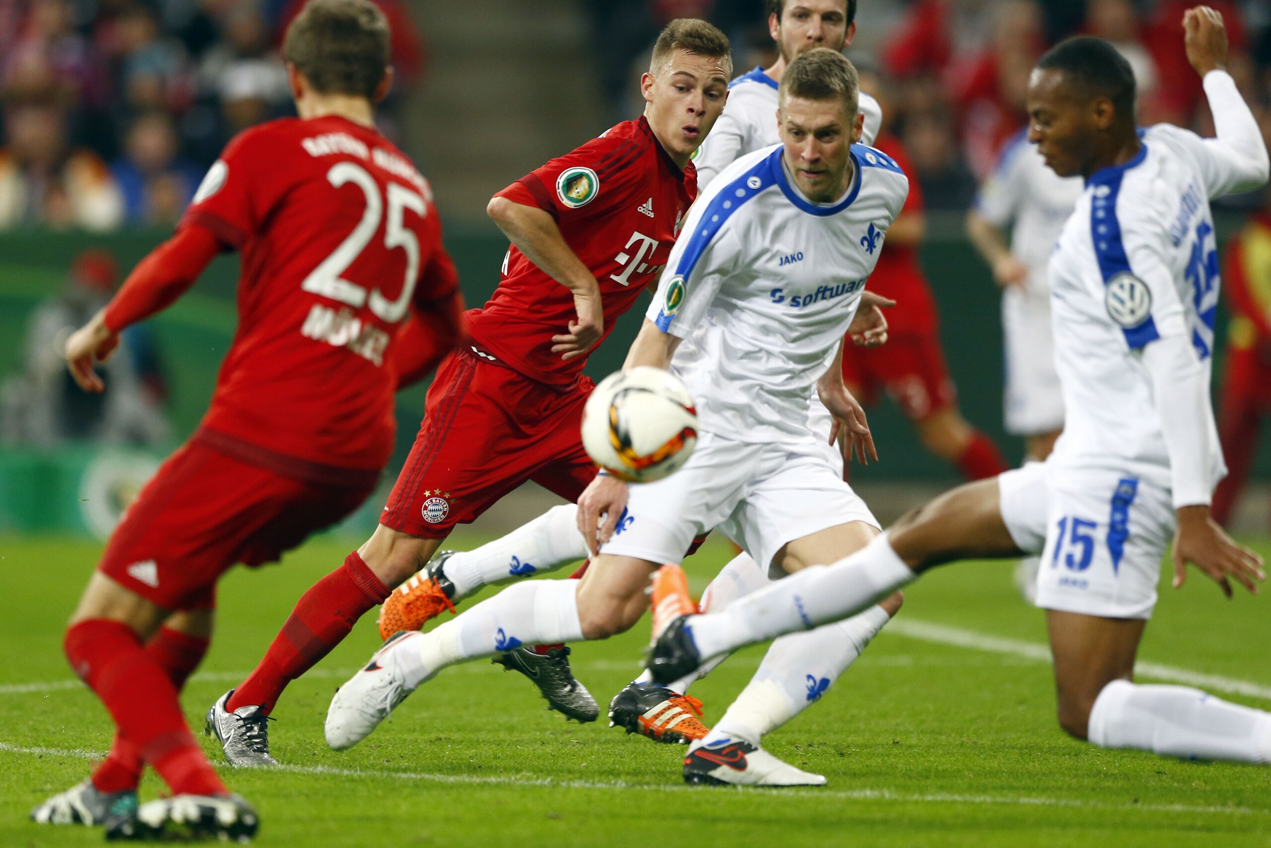 Bayern's Joshua Kimmich, background left, and Darmstadt's Slobodan Rajkovic challenge for the ball during the German soccer cup (DFB Pokal) match between FC Bayern Munich and SV Darmstadt 98 at the Allianz Arena stadium in Munich, Germany, Tuesday, Dec. 15, 2015. (AP Photo/Matthias Schrader) Bayern's Joshua Kimmich, background left, and Darmstadt's Slobodan Rajkovic challenge for the ball during the German soccer cup (DFB Pokal) match between FC Bayern Munich and SV Darmstadt 98 at the Allianz Arena stadium in Munich, Germany, Tuesday, Dec. 15, 2015. (AP Photo/Matthias Schrader)