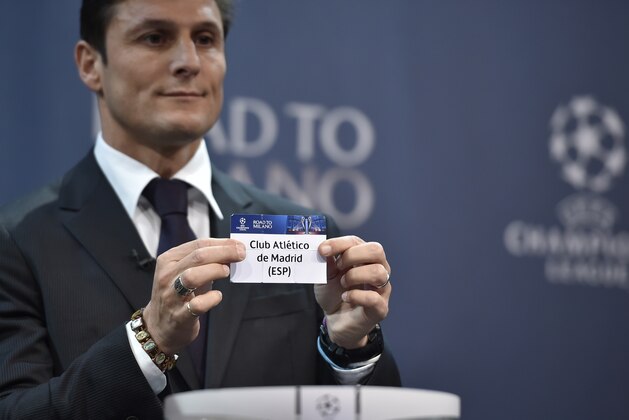 UEFA Champions League final ambassador  Javier Zanetti shows the name of  Athletico Madrid football club during the draw for the UEFA Champions league round of sixteen, on December 14, 2015 at the UEFA headquarters in Nyon.  AFP PHOTO / FABRICE COFFRINI / AFP / FABRICE COFFRINI        (Photo credit should read FABRICE COFFRINI/AFP/Getty Images)