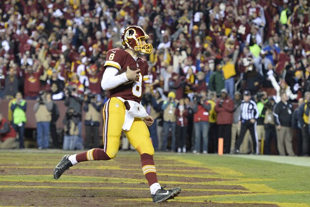 Jan 10, 2016; Landover, MD, USA; Washington Redskins quarterback Kirk Cousins (8) scores a touchdown against the Green Bay Packers during the second half in a NFC Wild Card playoff football game at FedEx Field. Mandatory Credit: Tommy Gilligan-USA TODAY Sports