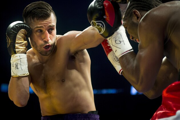 French-Cameroonian boxer Hassan N'Dam (R) defends against Canadian David Lemieux (L) during their IBF world middleweight championship in Montreal,  Canada,  June 20, 2015 Lemieux knocked down N'Dam four times en route to a unanimous 12-round decision to claim the vacant International Boxing Federation middleweight world title.   AFP PHOTO / Peter McCabe        (Photo credit should read Peter McCabe/AFP/Getty Images)