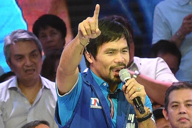 Senatorial candidate of the opposition party and boxing icon Manny Pacquiao speaks during their proclamation rally in Manila on February 9, 2016. A cliffhanger race to lead the Philippines began February 9 with emotion-charged rallies by a dead movie star's adopted daughter, a politician who brags about killing criminals and other top contenders.  AFP PHOTO / TED ALJIBE / AFP / TED ALJIBE        (Photo credit should read TED ALJIBE/AFP/Getty Images)