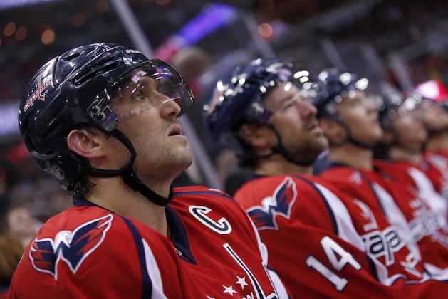 Washington Capitals left wing Alex Ovechkin, left, from Russia, sits on the bench in the third period of an NHL hockey game against the Los Angeles Kings, Tuesday, Feb. 16, 2016, in Washington. The Capitals won 3-1. (AP Photo/Alex Brandon)