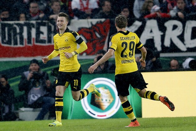 Dortmund's Marco Reus, left, celebrates his side's opening goal during a quarterfinal match of the German soccer cup between VfB Stuttgart and Borussia Dortmund in Stuttgart, Germany, Tuesday, Feb. 9, 2016. (AP Photo/Michael Probst)