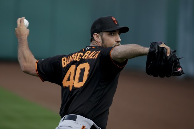 San Francisco Giants starting pitcher Madison Bumgarner throws during practice before the spring baseball season in Scottsdale, Ariz., Thursday, Feb. 18, 2016. (AP Photo/Chris Carlson)
