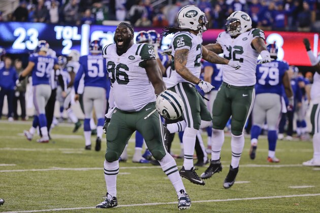 New York Jets' Muhammad Wilkerson (96) and Darrin Walls (26) celebrate after overtime of an NFL football game against the New York Giants Sunday, Dec. 6, 2015, in East Rutherford, N.J. The Jets won 23-20. (AP Photo/Julie Jacobson)
