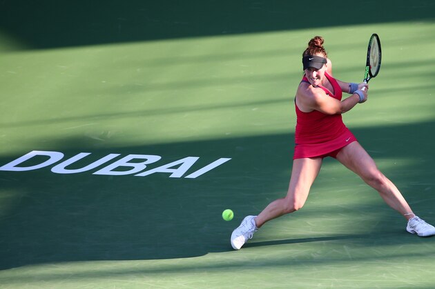 Madison Brengle of the USA returns the ball to Italian player Sara Errani during their quarter final WTA game as part of the Dubai Duty Free Tennis Championships, on February 18, 2016. / AFP / MARWAN NAAMANI        (Photo credit should read MARWAN NAAMANI/AFP/Getty Images)