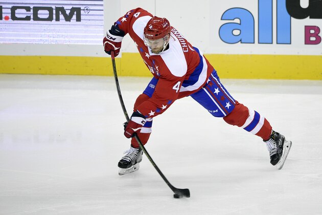 Washington Capitals defenseman Taylor Chorney (4) takes a shot during the third period of an NHL hockey game against the Philadelphia Flyers, Wednesday, Jan. 27, 2016, in Washington. The Flyers won 4-3 in overtime. (AP Photo/Nick Wass)