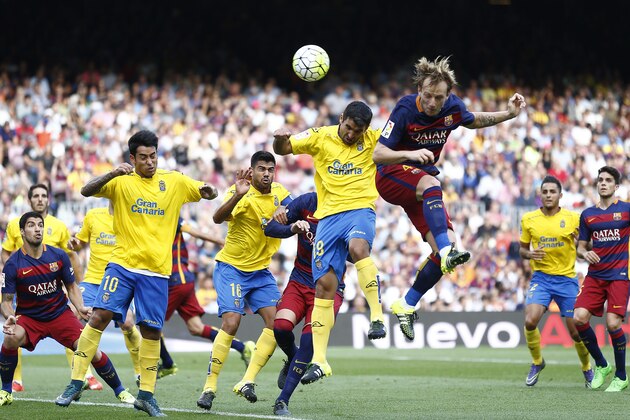 FC Barcelona's Ivan Rakitic, top right, duels for the ball against Las Palma's Juan Culio during a Spanish La Liga soccer match against Las Palmas at the Camp Nou stadium in Barcelona, Spain, Saturday, Sept. 26, 2015. (AP Photo/Manu Fernandez)