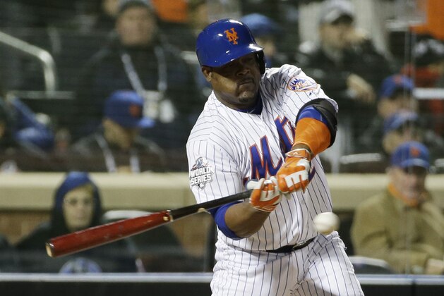 New York Mets' Juan Uribe hits an RBI single during the sixth inning of Game 3 of the Major League Baseball World Series against the Kansas City Royals Friday, Oct. 30, 2015, in New York. (AP Photo/David J. Phillip)