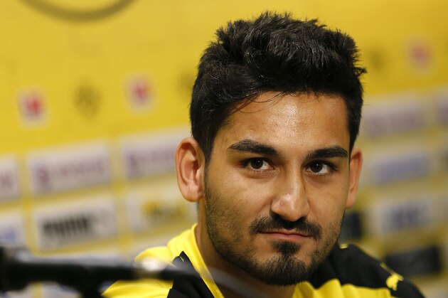 German soccer club Borussia Dortmund's Ilkay Guendogan listens to questions during a press conference, Wednesday, July 8, 2015, in Singapore. The team is in the city-state as part of their Asian tour. (AP Photo/Wong Maye-E)