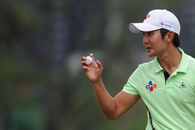Soomin Lee of South Korea acknowledges the crowd on the 18th hole during the third round of the 2016 Maybank Malaysia Championship golf tournament in Kuala Lumpur on February 20, 2016. AFP PHOTO / MOHD RASFAN / AFP / MOHD RASFAN        (Photo credit should read MOHD RASFAN/AFP/Getty Images)