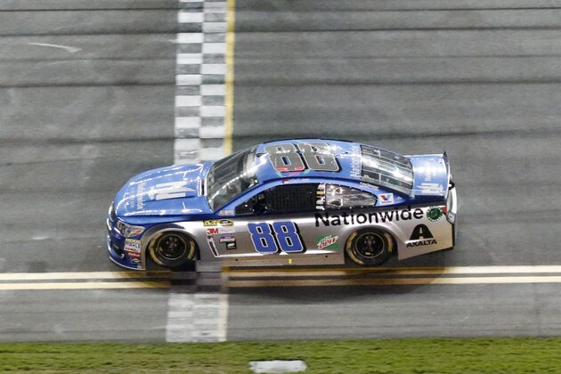 Dale Earnhardt Jr. crosses the finish line to win the first of two qualifying races for Sunday's NASCAR Daytona 500 Sprint Cup series auto race at Daytona International Speedway, Thursday, Feb. 18, 2016, in Daytona Beach, Fla. (AP Photo/Wilfredo Lee)