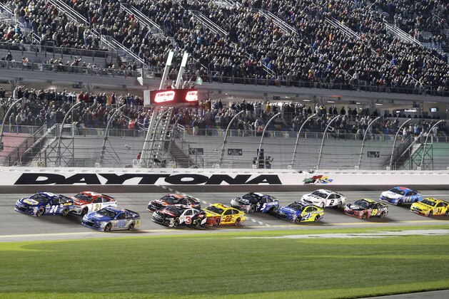 Chase Elliott (24) and Dale Earnhardt Jr (88) lead the field at the start of the first of two qualifying races for Sunday's NASCAR Daytona 500 Sprint Cup series auto race at Daytona International Speedway in Daytona Beach, Fla., Thursday, Feb. 18, 2016. (AP Photo/Terry Renna)
