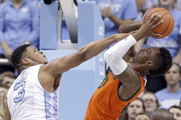 North Carolina's Kennedy Meeks (3) defends against Miami's Sheldon McClellan during the first half of an NCAA college basketball game in Chapel Hill, N.C., Saturday, Feb. 20, 2016. (AP Photo/Gerry Broome)
