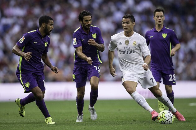 MADRID, SPAIN - SEPTEMBER 26: Cristiano Ronaldo (2ndR) of Real Madrid CF competes for the ball with Marcos Angeleri (2ndL) of Malaga CF and his teammates Juan Pablo Anor Acosta alias Juanpi (R) and Fernando Damian Tissone (L) during the La Liga match between Real Madrid CF and Malaga CF at Estadio Santiago Bernabeu on September 26, 2015 in Madrid, Spain.  (Photo by Gonzalo Arroyo Moreno/Getty Images)