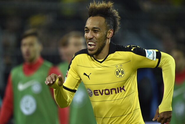 Dortmund's Pierre-Emerick Aubameyang  celebrates after scoring during the German Bundesliga soccer match between Borussia Dortmund and Eintracht Frankfurt in Dortmund, Germany, Sunday, Dec. 13, 2015. Dortmund defeated Frankfurt with 4-1. (AP Photo/Martin Meissner)