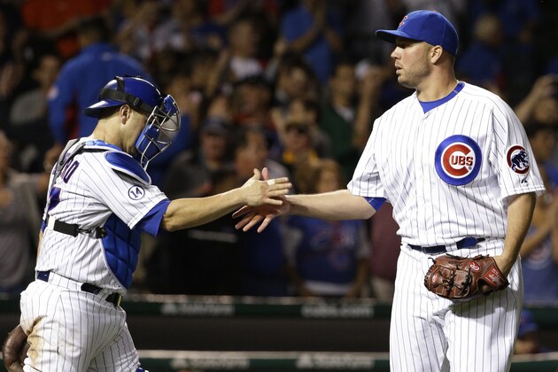 Chicago Cubs relief pitcher Tommy Hunter, right, celebrates with catcher Miguel Montero after the Cubs defeated the Atlanta Braves 7-1 in a baseball game Thursday, Aug. 20, 2015, in Chicago. (AP Photo/Nam Y. Huh)