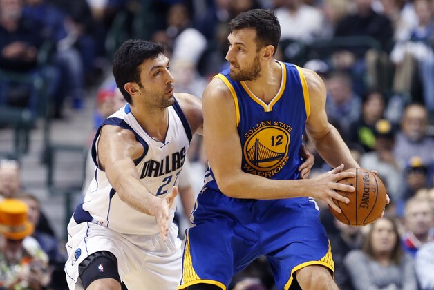 Dec 30, 2015; Dallas, TX, USA; Golden State Warriors center Andrew Bogut (12) dribbles as Dallas Mavericks center Zaza Pachulia (27) defends during the first half at American Airlines Center. Mandatory Credit: Kevin Jairaj-USA TODAY Sports