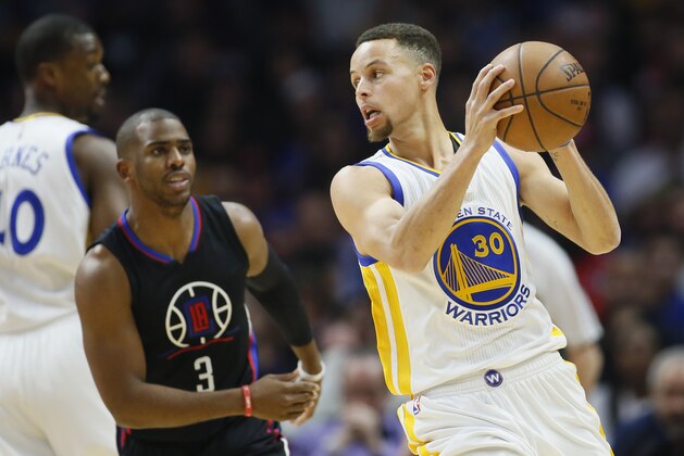 Golden State Warriors' Stephen Curry, right, controls the ball while Los Angeles Clippers' Chris Paul, left, defends during the first half of an NBA basketball game Saturday, Feb. 20, 2016, in Los Angeles. (AP Photo/Danny Moloshok)