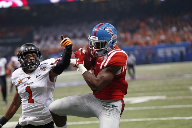 Mississippi wide receiver Laquon Treadwell (1) pulls in a touchdown reception in front of Oklahoma State cornerback Kevin Peterson (1) in the first half of the Sugar Bowl college football game in New Orleans, Friday, Jan. 1, 2016. (AP Photo/Bill Feig)