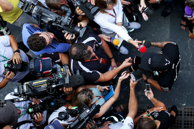 SAO PAULO, BRAZIL - NOVEMBER 12:  Lewis Hamilton of Great Britain and Mercedes GP speaks with members of the media in the paddock during previews for the Formula One Grand Prix of Brazil at Autodromo Jose Carlos Pace on November 12, 2015 in Sao Paulo, Brazil.  (Photo by Mark Thompson/Getty Images)