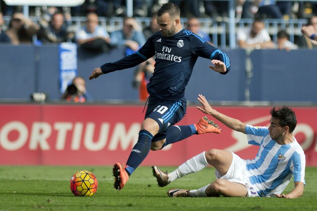 Real Madrid's forward Jese Rodriguez Ruiz (L) vies with Malaga's Portuguese forward Ricardo Horta during the Spanish league football match Malaga CF vs Real Madrid CF at La Rosaleda stadium in Malaga on February 21, 2016. / AFP / JORGE GUERRERO        (Photo credit should read JORGE GUERRERO/AFP/Getty Images)