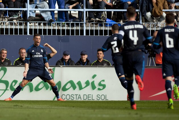 Real Madrid's Portuguese forward Cristiano Ronaldo (L) celebrates a goal during the Spanish league football match Malaga CF vs Real Madrid CF at La Rosaleda stadium in Malaga on February 21, 2016. / AFP / JORGE GUERRERO        (Photo credit should read JORGE GUERRERO/AFP/Getty Images)