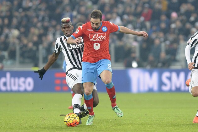 Napoli's Gonzalo Higuain challenges the ball with Juventus' Paul Pogba during a Serie A soccer match between Juventus and Napoli at the Juventus stadium, in Turin, Italy, Saturday, Feb. 13, 2016. (AP Photo/ Massimo Pinca)