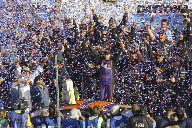 Denny Hamlin, center, celebrates in Victory Lane after winning the NASCAR Daytona 500 Sprint Cup Series auto race at Daytona International Speedway in Daytona Beach, Fla., Sunday, Feb. 21, 2016. (AP Photo/David Graham)