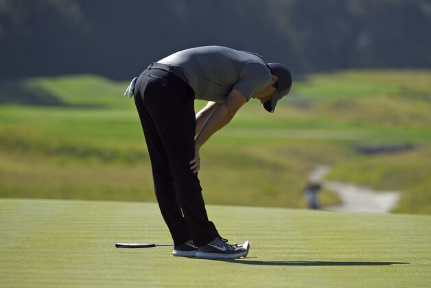Rory McIlroy, of Northern Ireland, reacts after missing a putt on the eighth green in the fourth round of the Northern Trust Open golf tournament, Sunday, Feb. 21, 2016, in the Pacific Palisades section of Los Angeles.(AP Photo/Mark J. Terrill)