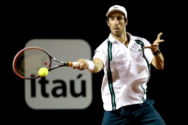 RIO DE JANEIRO, BRAZIL - FEBRUARY 21:  Pablo Cuevas of Uraguay returns a shot against  Guido Pella of Argentina during the final of the Rio Open at Jockey Club Brasileiro on February 21, 2016 in Rio de Janeiro, Brazil.  (Photo by Matthew Stockman/Getty Images)