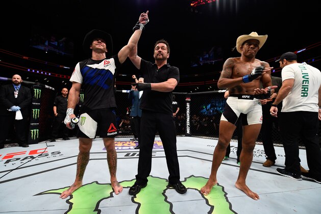 PITTSBURGH, PA - FEBRUARY 21:  (L-R) Donald Cerrone celebrates his submission victory over Alex Oliveira in their welterweight bout during the UFC Fight Night event at Consol Energy Center on February 21, 2016 in Pittsburgh, Pennsylvania. (Photo by Jeff Bottari/Zuffa LLC/Zuffa LLC via Getty Images)