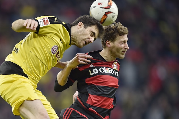 Dortmund's Sokratis, left, and Leverkusen's Stefan Kiessling challenge for the ball during the German Bundesliga soccer match between Bayer Leverkusen and Borussia Dortmund in Leverkusen, Germany, Sunday, Feb. 21, 2016. (AP Photo/Martin Meissner)