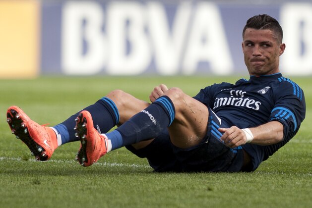Real Madrid's Portuguese forward Cristiano Ronaldo sits on the field during the Spanish league football match Malaga CF vs Real Madrid CF at La Rosaleda stadium in Malaga on February 21, 2016. / AFP / JORGE GUERRERO        (Photo credit should read JORGE GUERRERO/AFP/Getty Images)