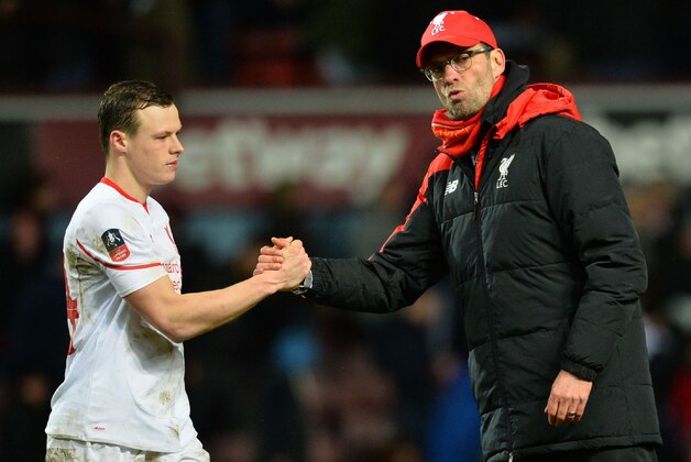 Liverpool's German manager Jurgen Klopp (R) shakes hands with Liverpool's Australian defender Brad Smith after the English FA Cup fourth round replay football match between West Ham United and Liverpool at The Boleyn Ground in Upton Park, east London, on February 9, 2016. West Ham won the game 2-1 after extra time. / AFP / GLYN KIRK / RESTRICTED TO EDITORIAL USE. No use with unauthorized audio, video, data, fixture lists, club/league logos or 'live' services. Online in-match use limited to 75 images, no video emulation. No use in betting, games or single club/league/player publications.  /         (Photo credit should read GLYN KIRK/AFP/Getty Images)