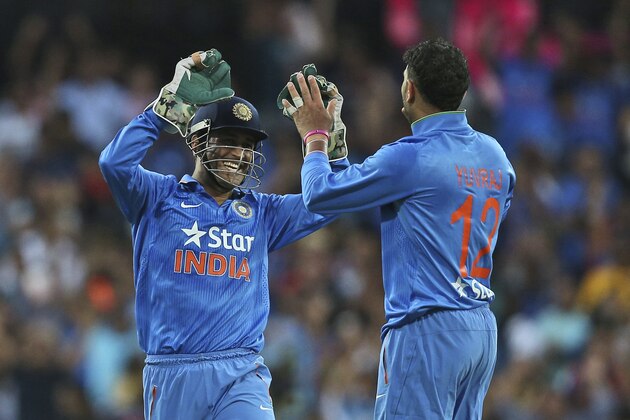 Indian bowler Yuvraj Singh, right, celebrates with MS Dhoni after taking the wicket of Australia's Glenn Maxwell during their T20 International cricket match in Sydney, Australia, Sunday, Jan. 31, 2016.(AP Photo/Rob Griffith)