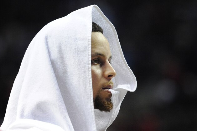 Feb 19, 2016; Portland, OR, USA; Golden State Warriors guard Stephen Curry (30) looks on from the bench during the third quarter of the game against the Portland Trail Blazers at the Moda Center at the Rose Quarter. The Blazers won the game 137-105. Mandatory Credit: Steve Dykes-USA TODAY Sports