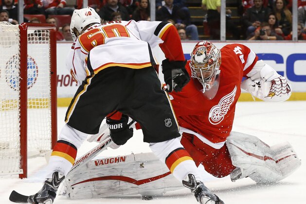 Detroit Red Wings goalie Petr Mrazek (34) stops a Calgary Flames center Markus Granlund (60) shot in the third period of an NHL hockey game, Sunday, Dec. 20, 2015 in Detroit. (AP Photo/Paul Sancya)