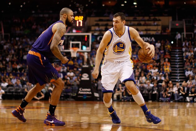 PHOENIX, AZ - FEBRUARY 10:  Andrew Bogut #12 of the Golden State Warriors handles the ball under pressure from Tyson Chandler #4 of the Phoenix Suns during the NBA game at Talking Stick Resort Arena on February 10, 2016 in Phoenix, Arizona.  The Warriors defeated the Suns 112-104. NOTE TO USER: User expressly acknowledges and agrees that, by downloading and or using this photograph, User is consenting to the terms and conditions of the Getty Images License Agreement.  (Photo by Christian Petersen/Getty Images)