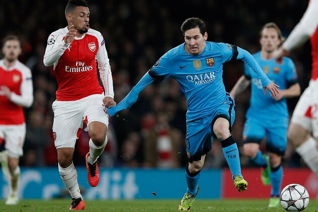 Arsenal's French midfielder Francis Coquelin (L) vies with Barcelona's Argentinian forward Lionel Messi during the UEFA Champions League round of 16 1st leg football match between Arsenal and Barcelona at the Emirates Stadium in London on February 23, 2016.  / AFP / ADRIAN DENNIS        (Photo credit should read ADRIAN DENNIS/AFP/Getty Images)