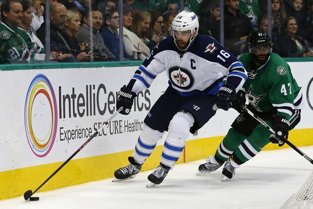 Winnipeg Jets' Andrew Ladd (16) controls the puck as Dallas Stars' Johnny Oduya (47) gives chase during the second period of an NHL hockey game, Thursday, Jan. 7, 2016, in Dallas. (AP Photo/Mike Stone)