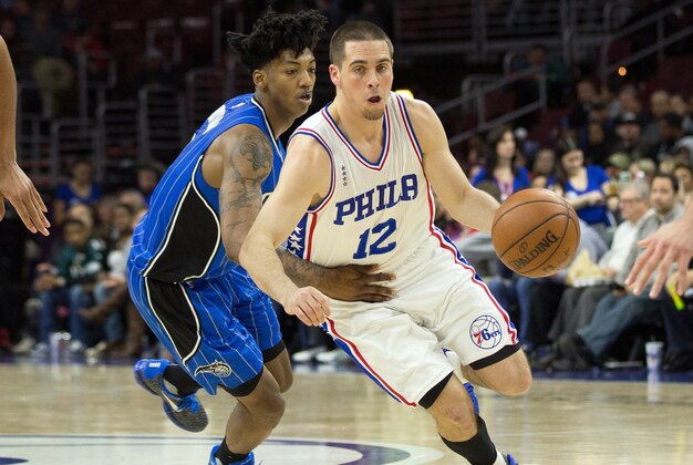 Feb 23, 2016; Philadelphia, PA, USA; Philadelphia 76ers guard T.J. McConnell (12) dribbles past the defense of Orlando Magic guard Elfrid Payton (4) during the first half at Wells Fargo Center. Mandatory Credit: Bill Streicher-USA TODAY Sports