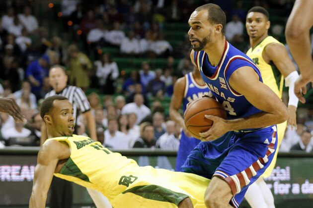 Baylor's Lester Medford is knocked backwards defending against Kansas forward Perry Ellis as Ellis positions for a shot in the first half of an NCAA college basketball game, Tuesday, Feb. 23, 2016, in Waco, Texas. (AP Photo/Tony Gutierrez)