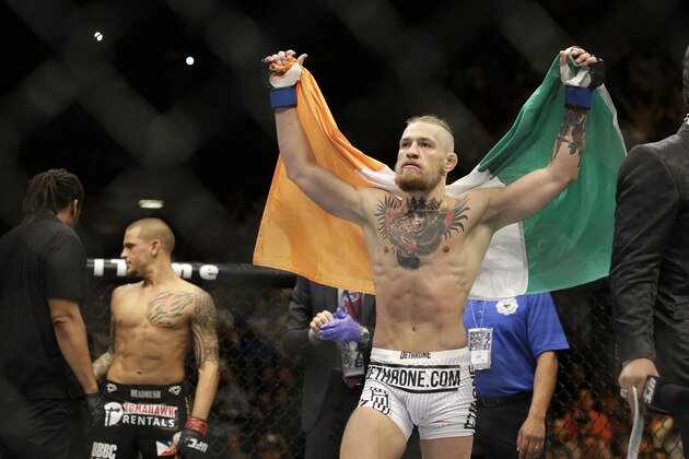 Connor McGregor celebrates after defeating Dustin Poirier in their featherweight mixed martial arts bout at UFC 178 on Saturday, Sept. 27, 2014, in Las Vegas. (AP Photo/John Locher)